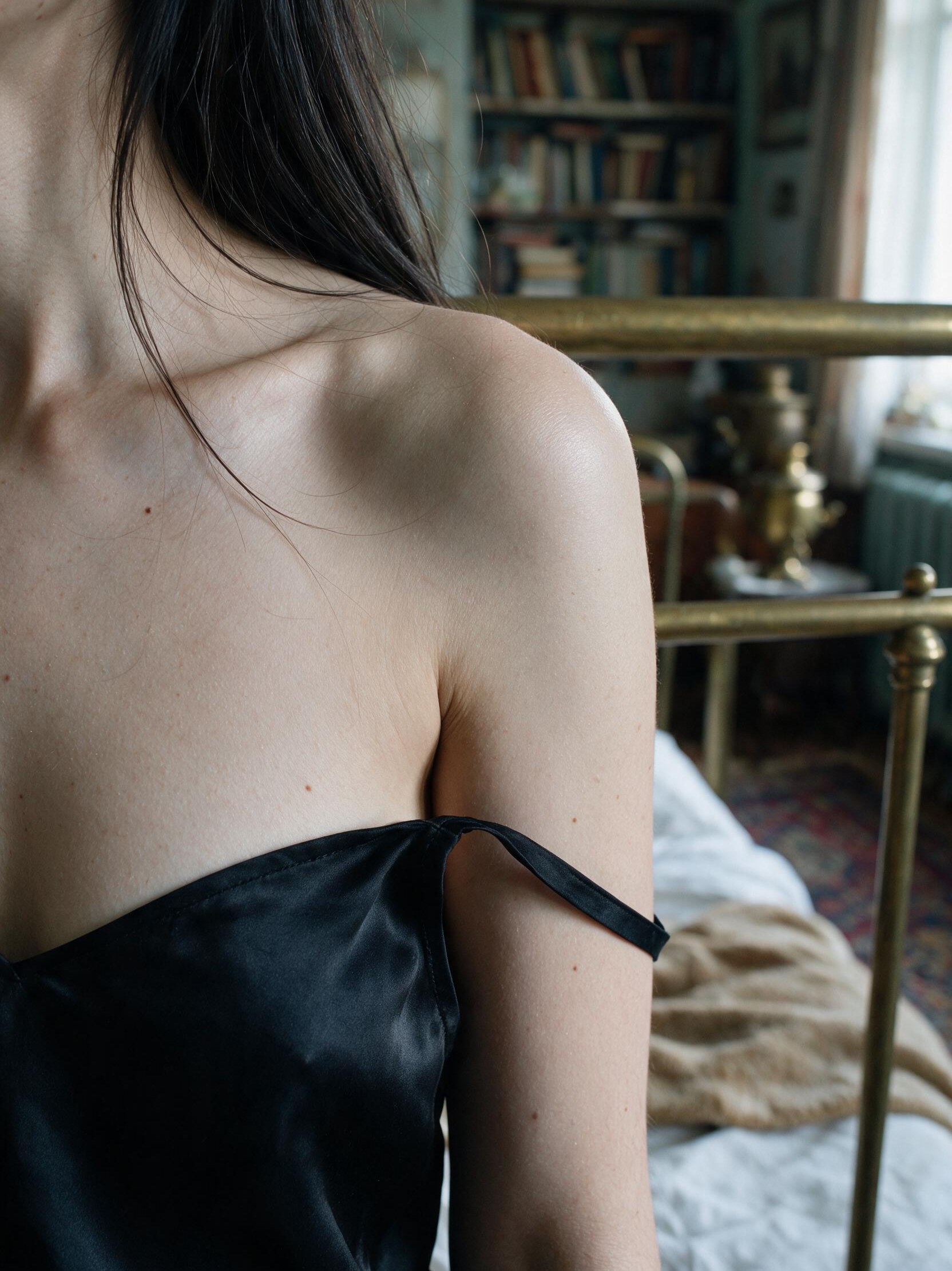 A slipped strap, a bare shoulder, the brass bed blurring softly behind me.