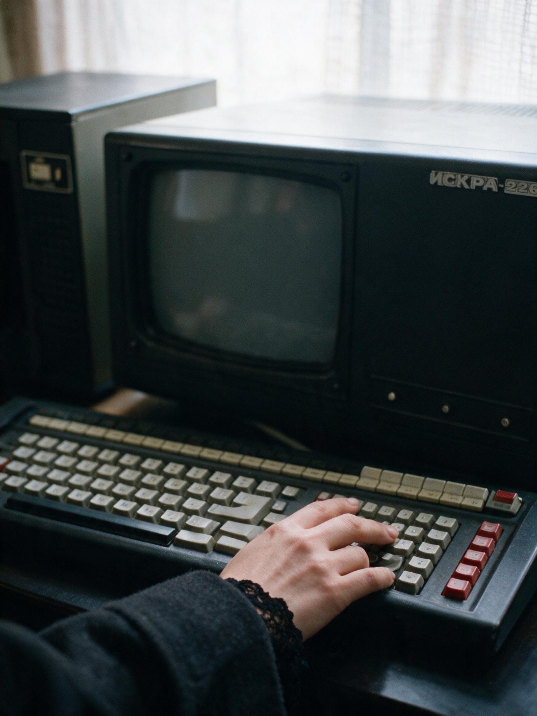 The machine against a wall in Almaty, keyboard out in front of it, the disks stacked beside it the way I found them.