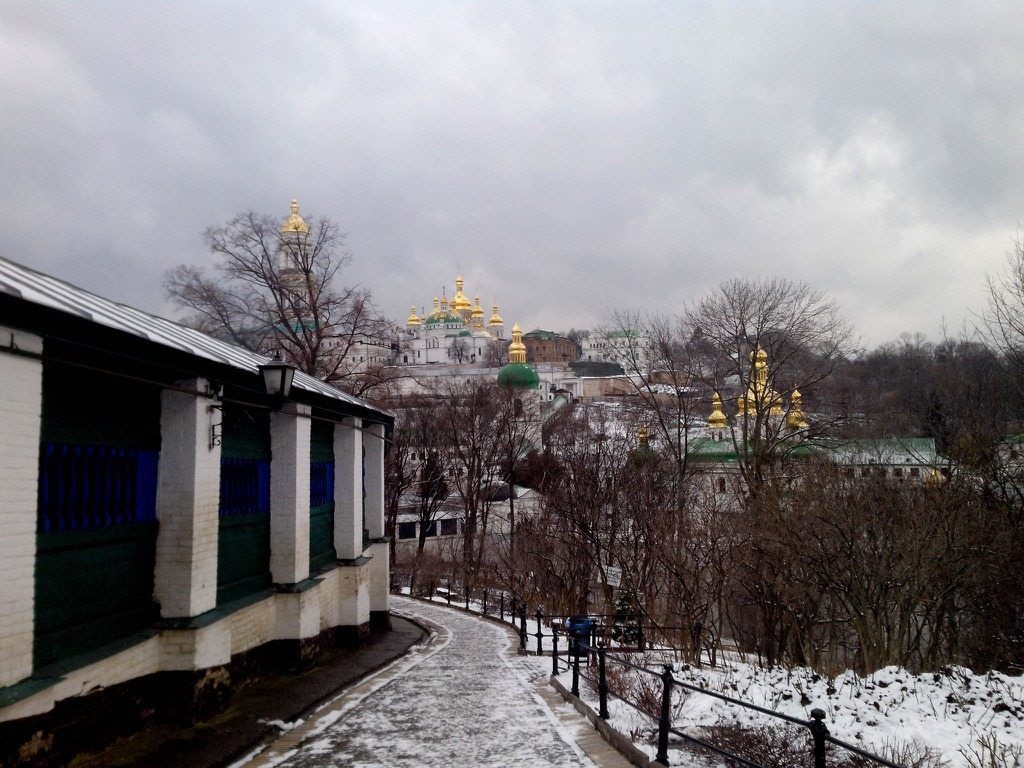 Snowy avenue at the Kyiv Pechersk Lavra, golden domes and the bell tower.