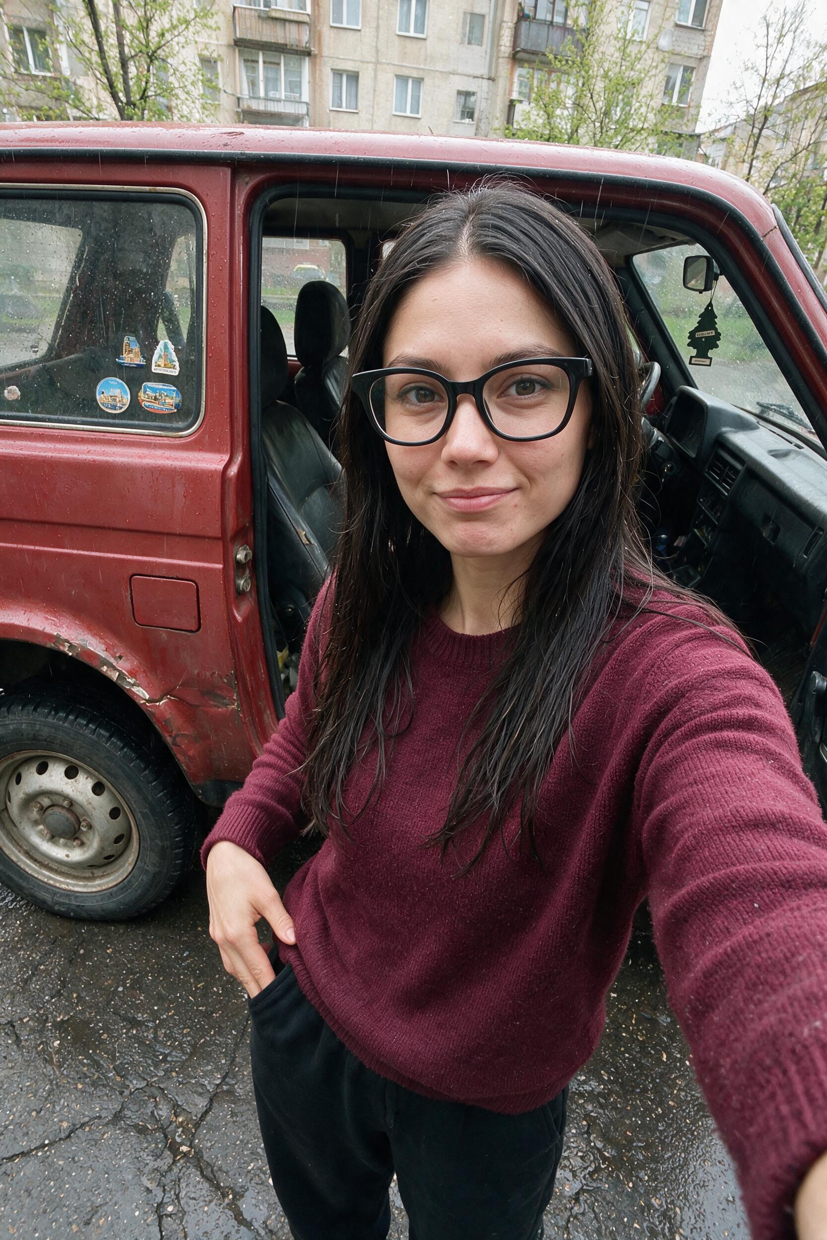 Woman by red Lada Niva checks empty pockets on a cracked street